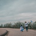 Two patriot jewish little girls running and enjoying with the flag of Israel on nature background. Royalty Free Stock Photo