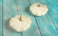 Two patty pan squashes on blue board desk Royalty Free Stock Photo