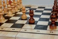 two pawns moving against each other on a chessboard, confrontation
