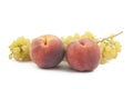 Two peaches and grapes branch on white Royalty Free Stock Photo