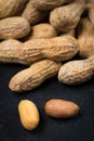Two Peanuts without Shells Infront of a Pile of Peanuts Close Up Royalty Free Stock Photo