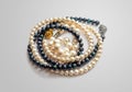 Two pearl necklaces made of black and white pearls and a bracelet made of white pearls Royalty Free Stock Photo