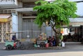 Two peddle under tree at noon, Vietnamese woman street vendor sell food and drink by handcart