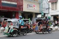Two pedicab drivers were driving to find passengers