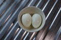 Two peeled hard-boiled eggs in a bowl Royalty Free Stock Photo