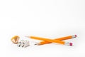 Two Pencils with pencil sharpener and sharpening shavings on white background. stationery.