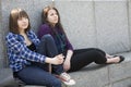 Two pensive teen girls sitting at river Royalty Free Stock Photo