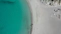 Two peole at the Punta Molentis Beach. Shadows of two people at the beach next to the ocean. Drone Shot Beach sardegna 2