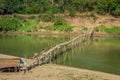 Two people on the bamboo bridge over the Nam Kahn River in Luang Prabang, Laos