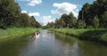 Two people on a boat floating on the river.