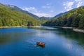 Two people on a boat on a lake in Montenegro.