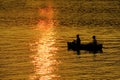 Two People in Canoe Fishing in Lake River at Sunset or Sunrise Royalty Free Stock Photo