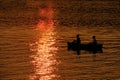 Two People in Canoe Fishing in Lake River at Sunset or Sunrise Royalty Free Stock Photo