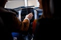 Two people in the car and the driver holding modern gadget