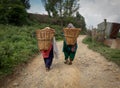 Two People Carrying Bamboo Baskets Royalty Free Stock Photo