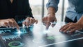 Two people collaborating on a futuristic interactive table displaying financial data and charts Royalty Free Stock Photo