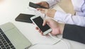 Two people connecting the mobile to a power bank.Technology device charge sharing concept Royalty Free Stock Photo