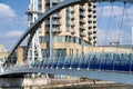 Two people crossing the Milennium bridge, Salford Quays, Manchester, England. Royalty Free Stock Photo