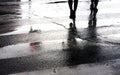 Two people crossing the street on a rainy day Royalty Free Stock Photo