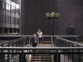 Portrait of Two people walking down stairs while looking up