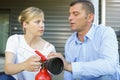 two people discussing how to use fire extinguisher correctly Royalty Free Stock Photo