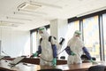 Two People Disinfecting Office