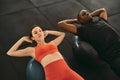 Two people doing exercises with fitness ball in gym Royalty Free Stock Photo