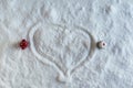 Two people dolls in winter clothes leave the heart zone on the snow. Aerial, top view. Concept of broken relationship.