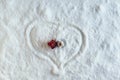 Two people dolls in winter clothes in the shape of heart on the snow. Aerial, top view. Concept of date valentine`s day