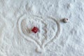 Two people dolls in winter clothes in the shape of heart on the snow. One man leaves the heart zone. Aerial, top view. Concept