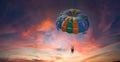 Two people enjoy parasailing flight during sunset bright colorful sky background Royalty Free Stock Photo