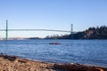 Two people enjoy a sunny day canoe ride out of Ambleside Beach