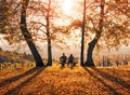 Two people enjoying an autumn afternoon on a bench