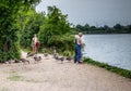 Two people feeding gooses