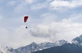 Two people flying with a Tandem and enjoying the freedom, high up in the sky with a few clouds and mountains covered in snow in Royalty Free Stock Photo