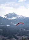 Two people flying with a Tandem and enjoying the freedom, high up in the sky with a few clouds and mountains covered in snow in Royalty Free Stock Photo