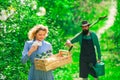 Two people gardening in the backyard garden. Portrait of a young happy couple in yard during spring season. Farming and