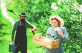 Two people gardening in the backyard garden. Portrait of a young happy couple in yard during spring season. Farming and