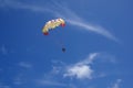 Two people glide with a parachute against the blue sky. Selective focus Royalty Free Stock Photo