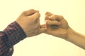 Two people hand hook little fingers together and swear friendship f