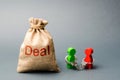 Two people are handcuffed to each other and stand next to the bag labeled Deal. Unclosed obligations between two persons