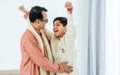 Two people of happy single Indian father, teenage handsome success son hugging with warmth, proud, love, wearing traditional