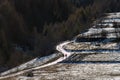 Two people hiking on a s shaped frosty road