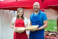 Two people holding baskets of baked goods Royalty Free Stock Photo