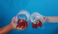 two people are holding glasses with alcoholic refreshing summer cocktail close-up on the background of the pool. the Royalty Free Stock Photo