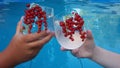 two people are holding glasses with alcoholic refreshing summer cocktail close-up on the background of the pool. the Royalty Free Stock Photo