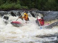 Two people on an inflatable catamaran struggling