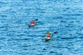 Two People are Kayaking in the Blue Mediterranean Sea - Liguria Italy Royalty Free Stock Photo