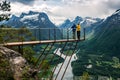 Two people are looking down from the observation deck rampestreken. Norway Royalty Free Stock Photo