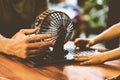 Two people Man adult boy hands caucasian skin together play loto board game. Lotto round sphere spins small orange balls Royalty Free Stock Photo